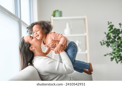 A Mother with little daughter at home sofa - Powered by Shutterstock