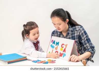 Mother and little girl are learning English letters - Shutterstock ID 2152415661