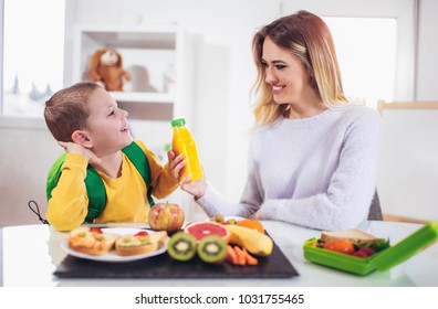 Mother Making Breakfast For Her Children In The Morning And A Snack For School