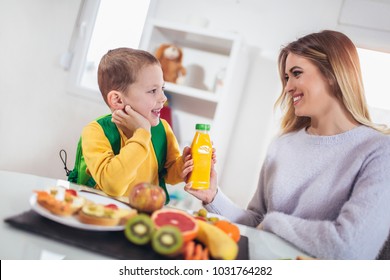 Mother Making Breakfast For Her Children In The Morning And A Snack For School