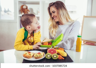 Mother Making Breakfast For Her Children In The Morning And A Snack For School