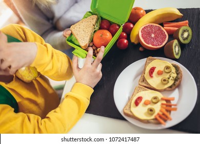 Mother Making Breakfast For Her Children In The Morning And A Snack For School