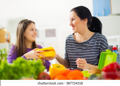 Mother making breakfast for her children in the morning and a snack for school at home - Powered by Shutterstock