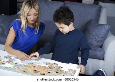 mother making a puzzle together with her son
