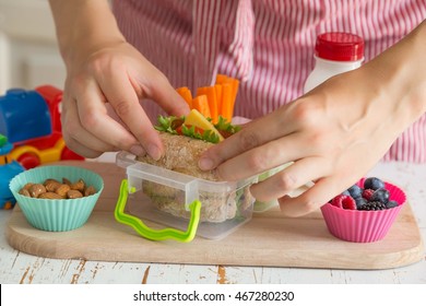 Mother Making School Lunch In The Kitchen