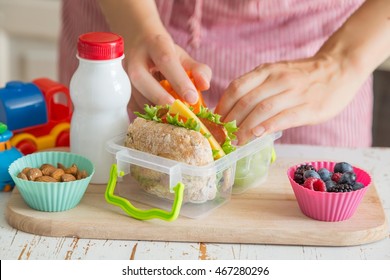 Mother Making School Lunch In The Kitchen
