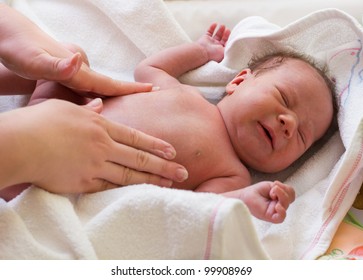 Mother massaged crying baby with colic