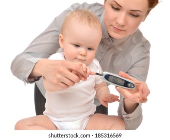 Mother Measuring Glucose Level Blood Chemistry Test From Diabetes Child Baby Using Glucometer And Small Drop Of Blood From Finger And Test Strips Isolated On A White Background