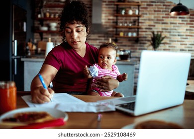 Mother multitasking while working from home with baby in arms - Powered by Shutterstock