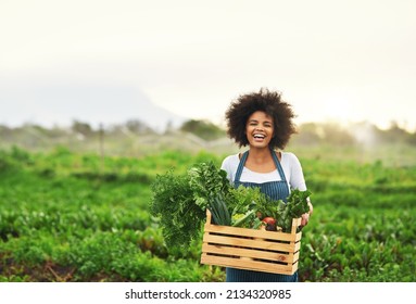 Mother nature provides. Cropped portrait of an attractive young female farmer carrying a crate of fresh produce. - Powered by Shutterstock