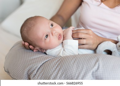 Mother With Newborn Baby In The Nursing Pillow