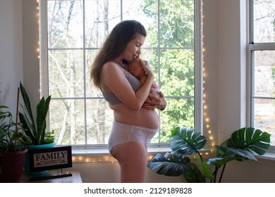 Mother With Newborn Baby. Postpartum. Fourth Trimester. Body Positivity. Postpartum Body