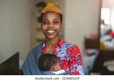 Mother With Newborn In Baby Sling Carrier At Home
