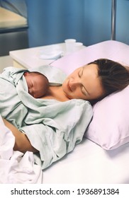 Mother And Newborn. Child Birth In Maternity Hospital. Young Mom Hugging Her Newborn Baby After Delivery. Woman Giving Birth. First Moments Of Baby Life After Labor.