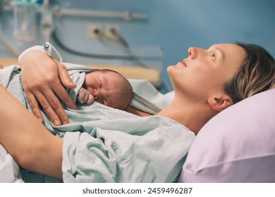 Mother and newborn. Child birth in maternity hospital. Young mom hugging her newborn baby after delivery. Woman giving birth. First moments of baby life after labor. - Powered by Shutterstock