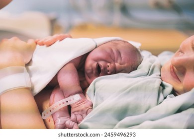 Mother and newborn. Child birth in maternity hospital. Young mom hugging her newborn baby after delivery. Woman giving birth. First moments of baby life after labor. - Powered by Shutterstock