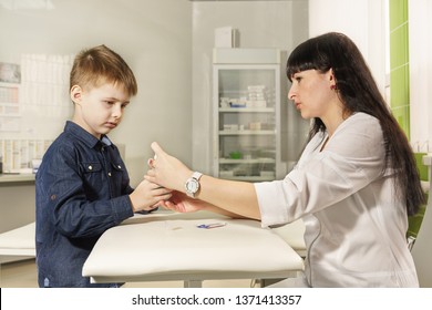 Mother - nurse teaches little son to disinfect wounds in cuts. Learning in a playful way. Child at work with mom
