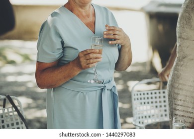 Mother Performing Speech At Wedding Reception For Daughter Bride And Toasting With Champagne. Stylish Old Woman Holding Glass Of Champagne And Cheering