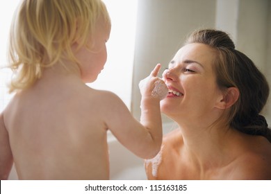 Mother Playing With Baby In Bathtub