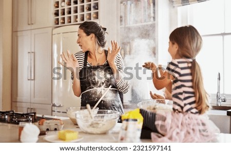 Mother, playing or girl baking in kitchen as a happy family with a playful young kid with flour at home. Dirty, messy or funny mom helping, cooking or teaching daughter to bake for child development