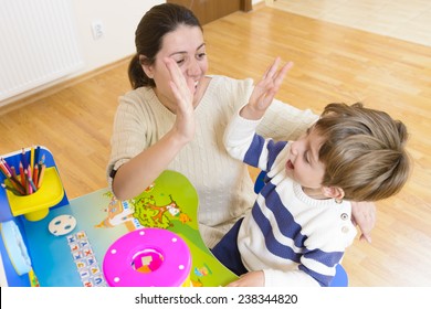 Mother playing with her child some creativity game and encouraging him