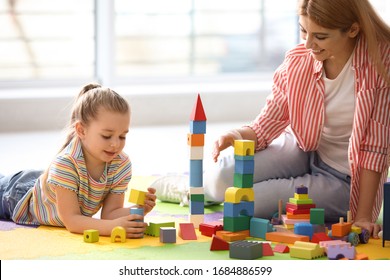 Mother Playing With Her Children At Home