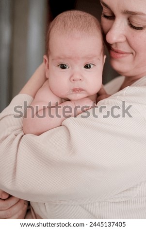 Mother playing with her newborn baby. Parenthood, childhood, motherhood