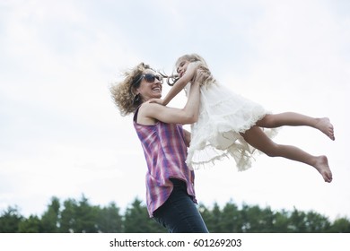 Mother Playing Outdoors With Her Daughter