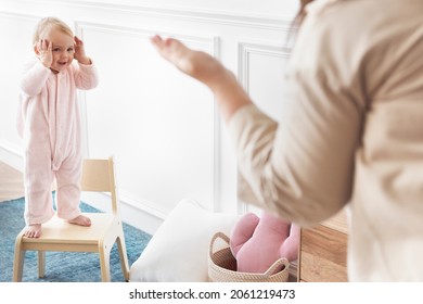 Mother Playing Peekaboo With Her Baby Girl