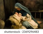 Mother playing Virgin Mary in a reenactment christmas nativity scene with her own 8 days old baby