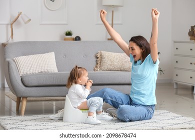 Mother Potty Training Her Little Daughter At Home