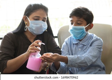 Mother pouring handwash sanitizer on palm of her son - Powered by Shutterstock