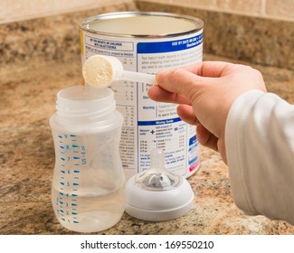 Mother Prepares Baby Milk Formula In Kitchen
