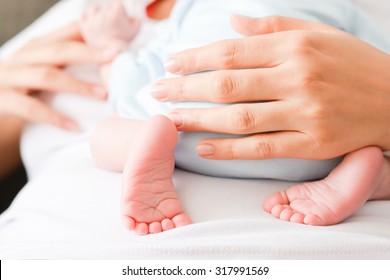 Mother protecting her newborn child - Shutterstock ID 317991569