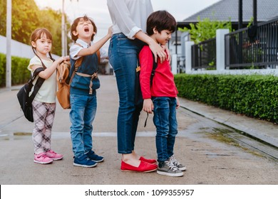 Mother And Pupil And Kids Holding Hands Going To School In First Class With Schoolbag Or Satchel Walking To School Bus, Parent And Son,sister Preschool 