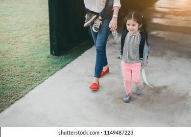 Mother And Pupil Kids Holding Hands Going To School In First Class With Satchel Walking To School Bus, Parent And Son,sister Preschool.