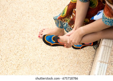 Mother Putting Colorful Aqua Shoes For Her Son Get Ready To The Beach