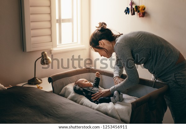Mother Putting Her Baby Sleep On Stock Photo Edit Now 1253456911