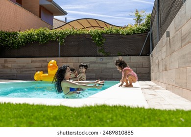 Mother reaches out to daughter on pool edge while father and son enjoy the water. Inflatable duck floats nearby, family enjoying sunny day. - Powered by Shutterstock