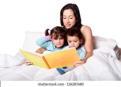 Mother Reading Bed Time Story Book To Daughter And Son Kids In Bed, Isolated.