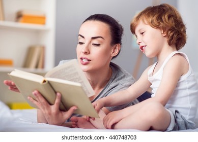 Mother reading book for her son