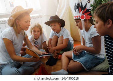 Mother Reading To The Children At Their Room. Wild West Story. Storytelling.