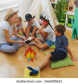 Mother Reading To The Children At Their Room. Wild West Story. Storytelling.