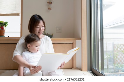 A Mother Reads A Picture Book For Her Child