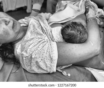 Mother Rest With Her Newborn Baby In Bed Second After Birth Labour. Pregnant Woman, Newborn, Baby, Pregnancy Concept.