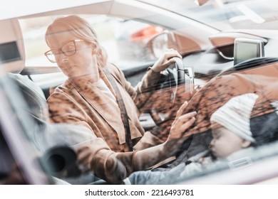 Mother Reversing Family Car, Looking For Free Parking Space While Running Errands With Her Baby Sleeping In Infant Car Seat By Her Site.