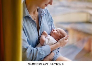 Mother Rocks The Child. Portrait Of A Sleeping Newborn In Mother's Arms. Caring Love Tenderness. Motherhood. Sings Lullaby. Baby Healthy Sleep. Young Mom. Infant Cute Sweet Little. Real Life Lifestyle