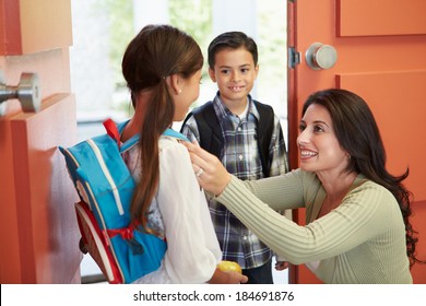 Mother Saying Goodbye To Children As They Leave For School