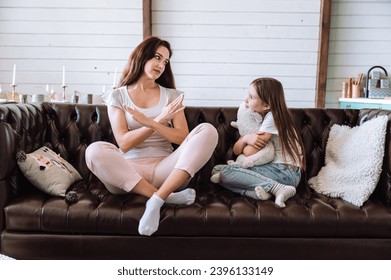 Mother saying no and setting limits. Woman imposing boundaries in non-permissive parenting style upbringing. Female talking wih kid about conflict, quarrel at home