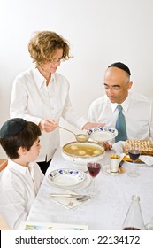 Mother Serving Kneidel Soup At Passover Family Seder